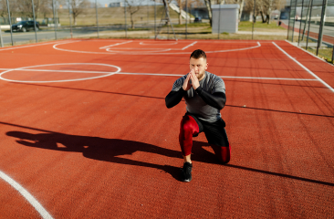 Athlete performing squat assessment on outdoor court — return to play physiotherapy Melbourne